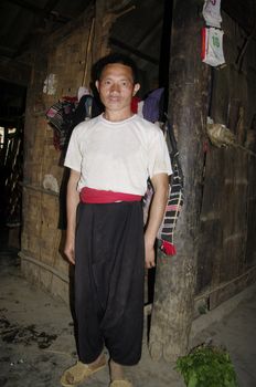 Black pants, black jacket and red sash are typical of the men held the Hmong.