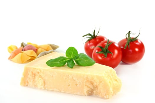 a piece of Parmesan cheese with basil and tomato
