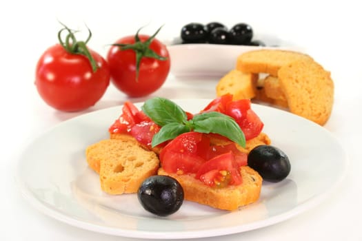 Bruschetta with tomatoes, olives and basil