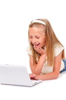 Happy and smiling little girl with laptop on white background isolated
