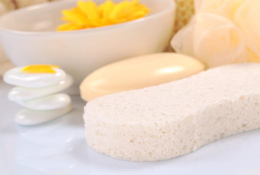 Spa still life with sponge, flower and soap (Selective Focus, Focus on the front of the sponge)