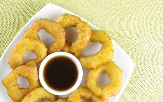 Popular Peruvian dessert called Picarones made from squash and sweet potato and served with chancaca syrup (kind of honey)