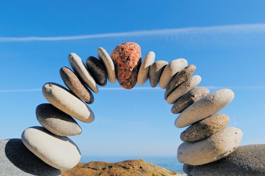 Red stone in the center arch of pebbles