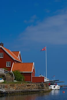 Red wooden house in Lyngor along the Southern-Norwegian coast