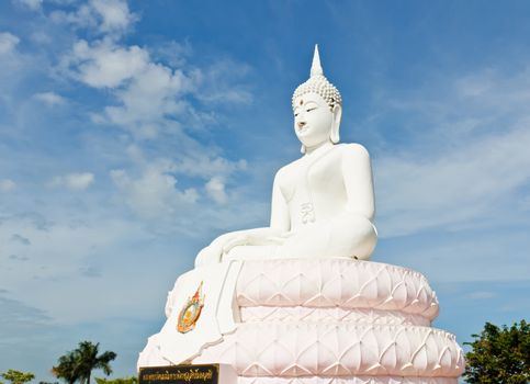 White Buddha statue with blue sky.