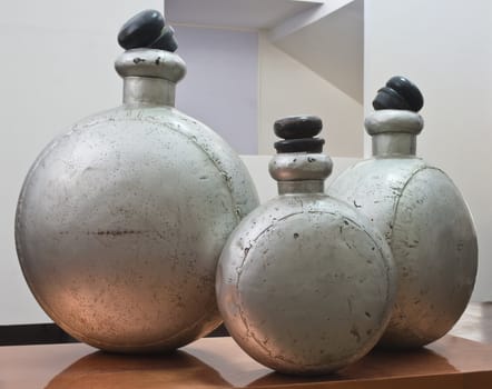 old metal bottles with wooden tops on a table