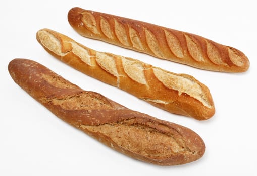 Three different French baguettes against a white background.