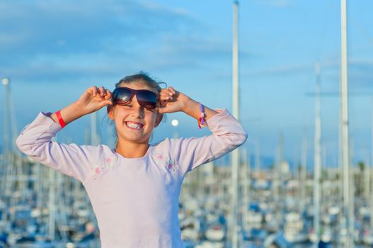 Closeop Portrait of a cute girl in the background of yachts