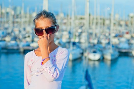 Closeop Portrait of a cute girl in the background of yachts