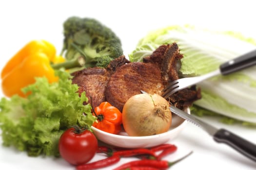 Baked cutlet on a plate with several ingredients
