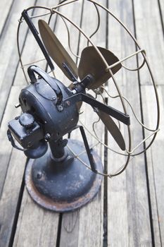 four brass bladed electric fan in outdoor setting