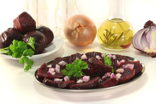 red beet salad with red onions and parsley on a white background