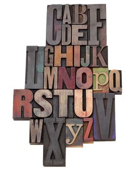 English alphabet abstract  in antique wood letterpress printing blocks of different size and style, isolated on white