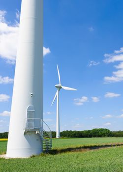 Wind generators under blue cloudy sky