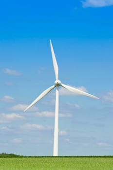 Wind generator under blue cloudy sky