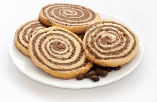 black and white cookies with coffee beans on the plate on white background