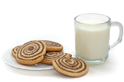 black and white cookies on the plate with cup of milk on white background