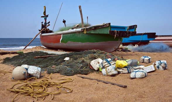 fisherman boat and tackle including nets left on a beach for next trawl