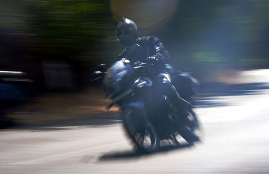 Indian biker speeds along Mumbai Goa road India with copy space