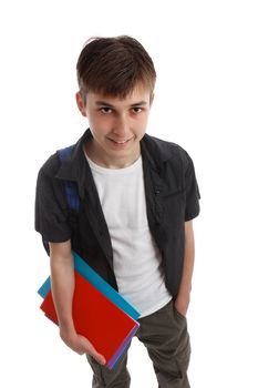 A smiling teenage boy holding some books in one hand and a backpack over the shoulder.  White background.