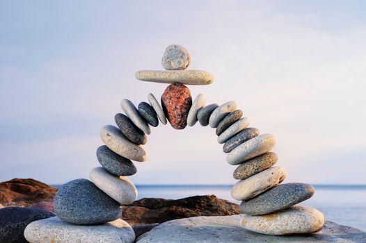 Pebbles curved as arch on the seashore