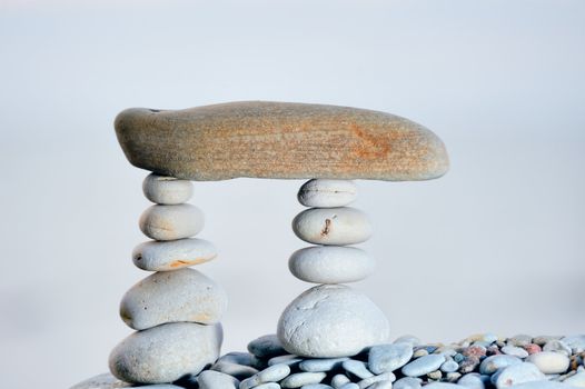 Long horizontal stone between a two piles of pebbles