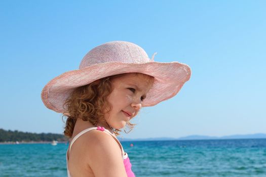 little girl with straw hat portrait