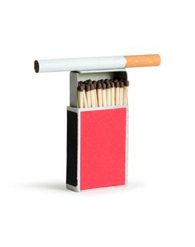 Cigarette lying on open matchbox. Isolated on white with clipping path