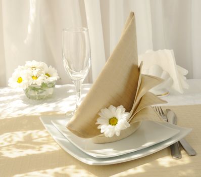 Coordinated decorative napkin on a plate with cutlery