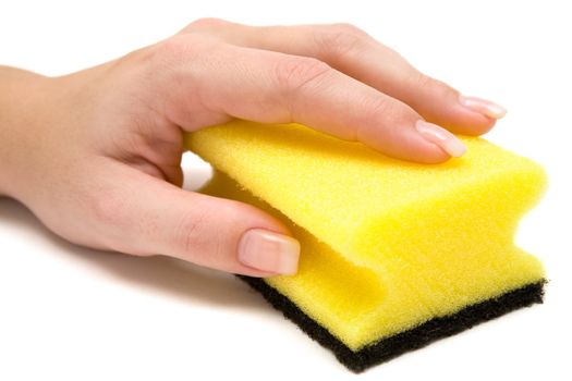 Female hand holding a yellow cleaning sponge. White background.