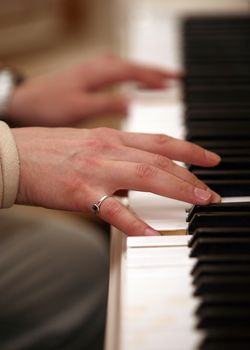 The image of the piano and man's hands