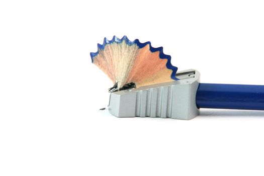 sharpening a pencil with  sharpener isolated on white background