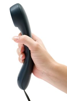 Female hand holding a dark blue phone receiver. Isolated on a white background.