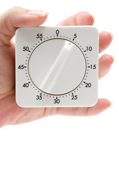 Female hand holding a timer. Isolated on a white background.