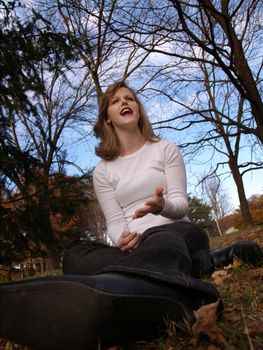 Woman sitting in park, complaining about something.