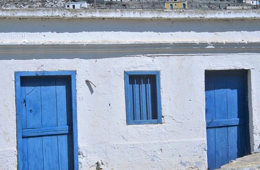 White walls, blue doors and windows are a part of traditional greek style in architecture.