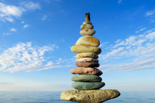 Stack of pebbles against the blue sky