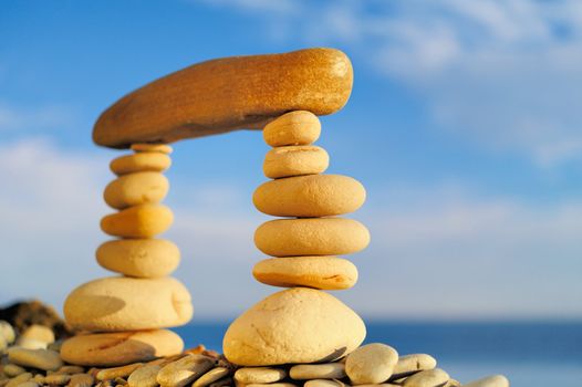 Long horizontal stone between a piles of pebble
