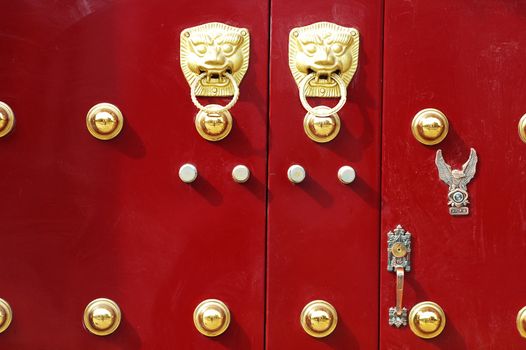 Traditional Chinese red door decorated with golden door knobs