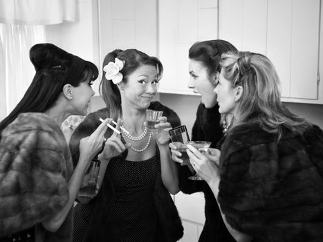 Four Caucasian women in mink coats smoking and drinking