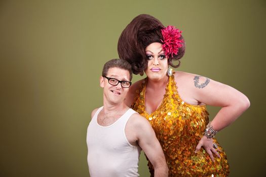 Tall drag queen with shorter man in glasses