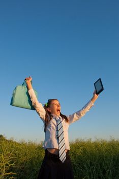 Teen girl with electronic book reader outdoors