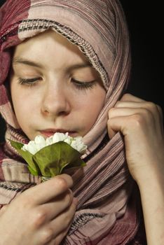 Little girl muffled in a shawl with flowers