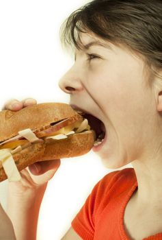 Teen girl eats a huge hamburger