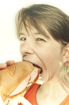 Teen girl eats a huge hamburger