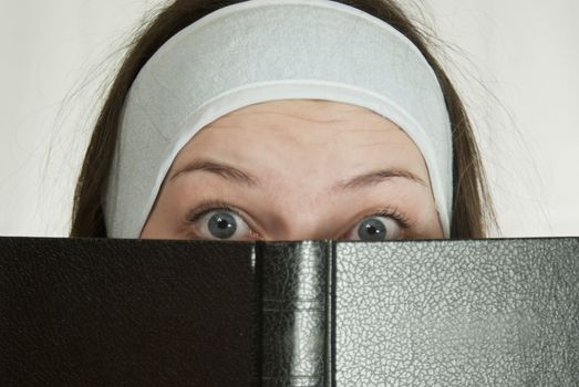 Surprised teen girl with the Bible