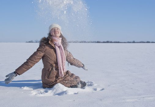 Teen girl playing with snow