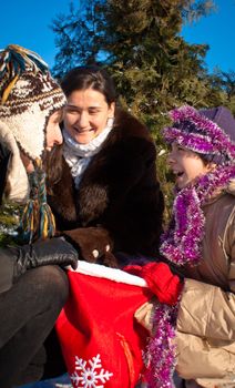 Girls looking into the bag with presents