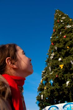 Girl looking at the Christmas tree