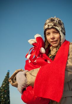 Girl holding a bag with Christmas presents